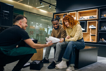 Naklejka premium Couple buying sneakers in a store