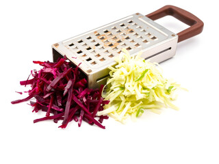 A grater full of shredded vegetables including purple cabbage and green zucchini