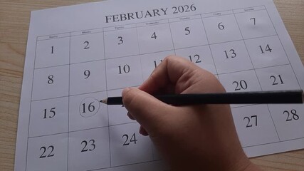 marking 16 February date on the calendar
