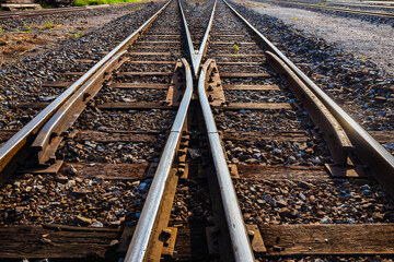 Fototapeta premium old railway crossing point that uses wooden supports for the steel bars.