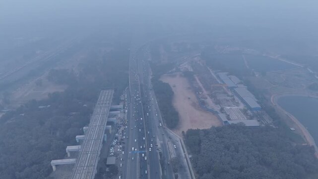 Aerial view of Sarai Kale Khan, Delhi, showing traffic and urban infrastructure under dense smog and poor air quality