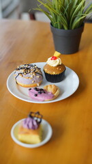 a cupcake on a white plate on a wooden table, breakfast menu in the morning, with natural lighting in the morning