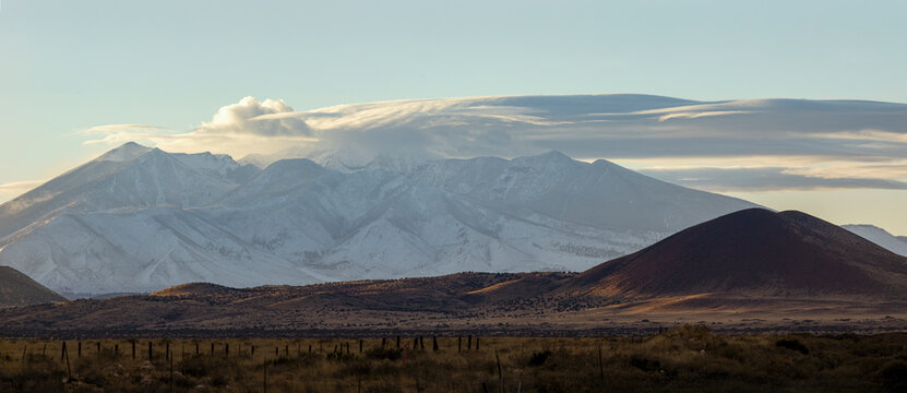 Dramatic clouds over snowy mountain landscape