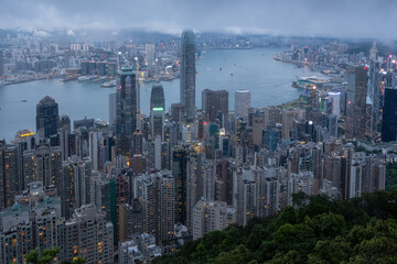 Viewed From Victoria Peak Over Hong Kong Night Skyline With Illuminated Skyscrapers And Dense...