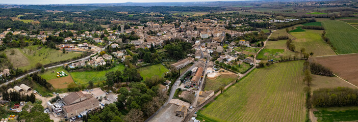 Aerial panoramic view of the old town city Castelnau-de-Guers in France on a sunny noon