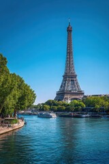 The Eiffel Tower is tall and majestic, standing tall over the water