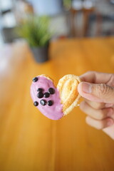 a cupcake on a white plate on a wooden table, breakfast menu in the morning, with natural lighting in the morning