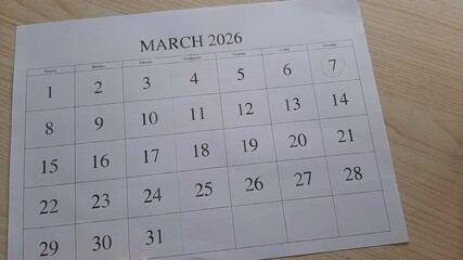 marking 7 March date on the calendar

