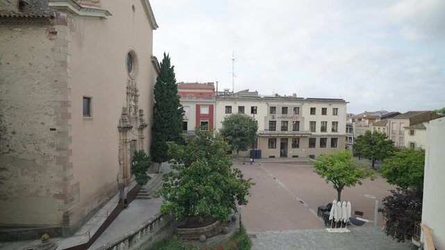 Aerial view of a peaceful square in La Garriga, Barcelona, showcasing historic architecture and serene surroundings.