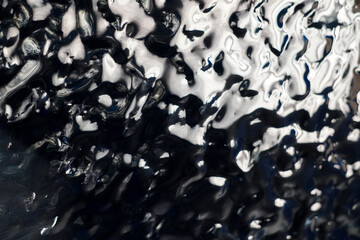 Abstract photographs depict glossy and rough surfaces resembling liquid metal or rippling water....