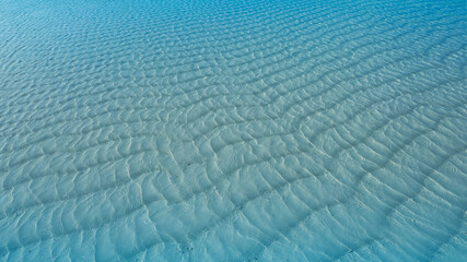 Summer lagoon Ripples in the sand at low tide on a beach with sandbar and blue sea in Maldives island
