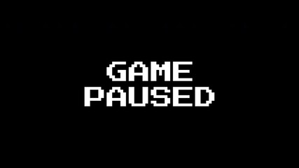 Pausing vhs white text saying game paused on black background. Suitable for use in online gaming websites and blog posts.