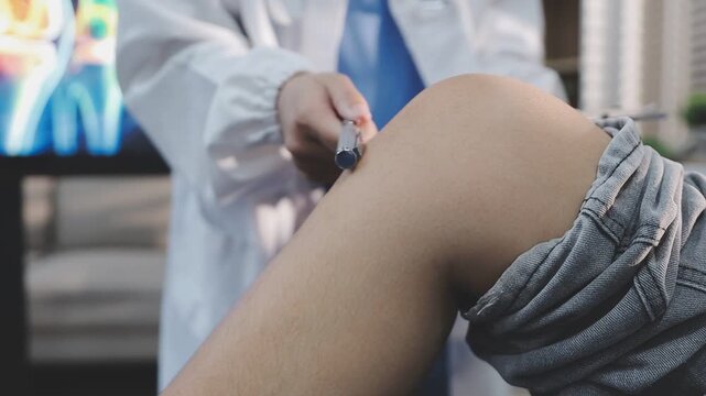 A close-up of a physical therapist or podiatrist examining and treating a patient's foot and ankle.