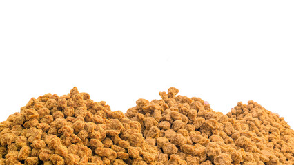 close-up macro view of jaggery pieces, golden brown colored cube shaped unrefined sugar product also called kithul jaggery or palm sugar, sweet and sugary traditional food in southeast asia isolated, 