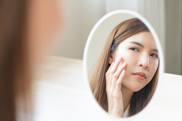 Anti aging, worry puberty asian young woman, stressed girl looking in mirror, allergy presenting an...