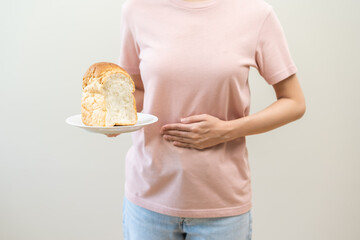 Gluten allergy woman hand holding, refusing to eat white loaf slice on plate in breakfast food meal...