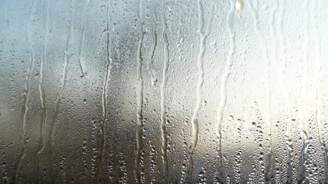 Rain, drops on the glass. Water is flowing.
