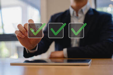 Businessman using pen tick check mark, digital documents and files hologram. Copy space, business...