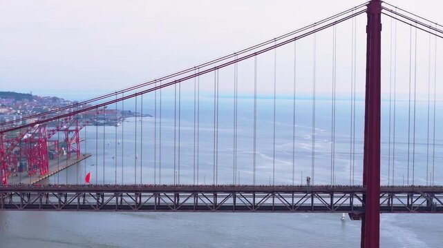 Side-on aerial drone shot of half marathon and 10K long-distance running event in Lisbon, Portugal, Europe. Commercial grading, Alcantara docks