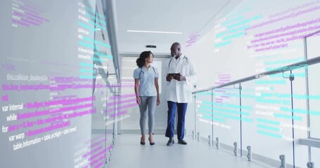 Walking through corridor, healthcare professionals discussing patient data over programming code - Powered by Adobe