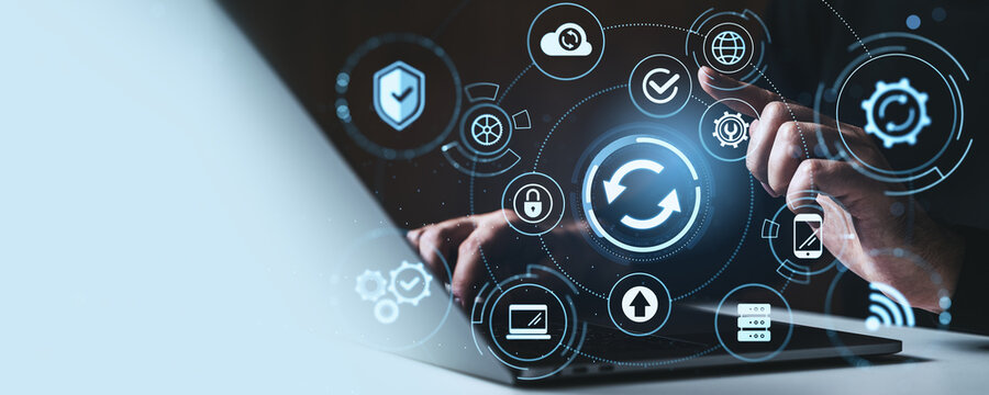 Digital synchronization and cloud technology concept with user interacting through laptop and futuristic interface on a creative background.