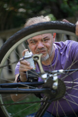 Middle Aged Man Repairing Bicycle at Home