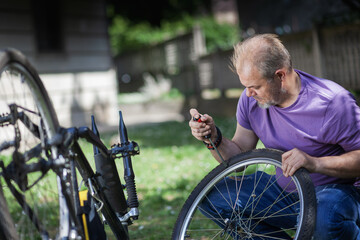 Middle Aged Man Repairing Bicycle at Home