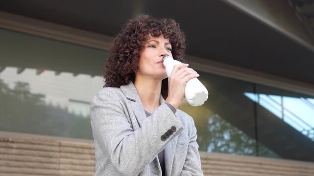 A Young Woman Holding a Milk Bottle While Posing in an Outdoor Setting in Nature