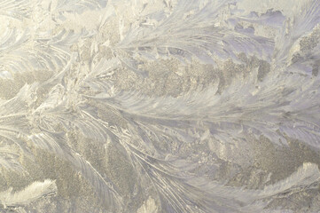 Natural background. Frost patterns on glass in winter.