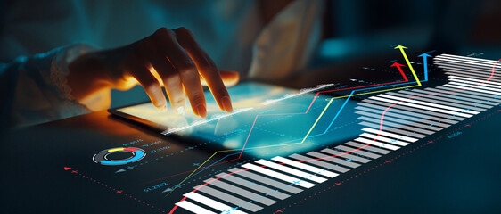 Professional analyzing financial data on tablet with futuristic interface showcasing graphs, charts, and statistics in a modern business setting