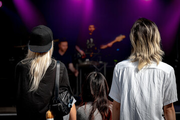 Young people listening to live music concert