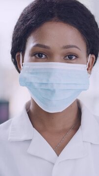 Scientist, face of woman and mask in lab for compliance, medical research or cure development. Pathologist, black person or safety for science experiment, vaccine innovation or ready for pharma study