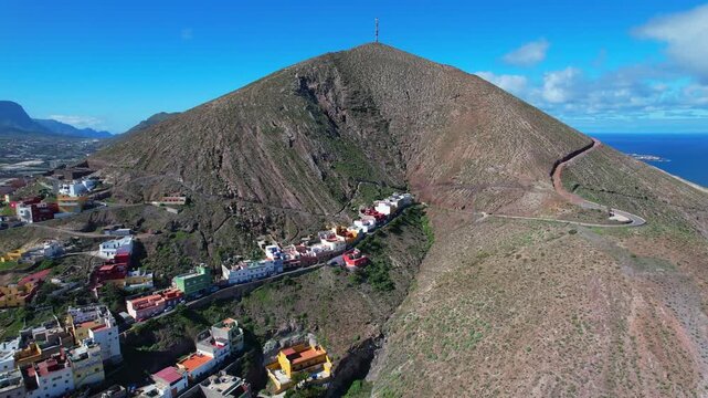 Aerial shot of the volcanic landscape surrounding the town of Galdar on a sunny day in Gran Canaria