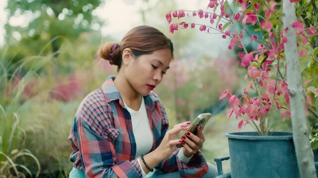 Young Woman Using Smart phone in Garden