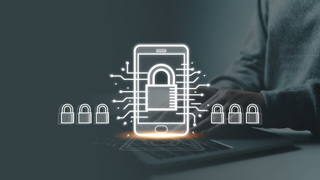 A user types on a laptop while a glowing smartphone hologram with a padlock icon and circuit lines appear, illustrating mobile cybersecurity and encrypted data safety for secure digital communication. - Powered by Adobe