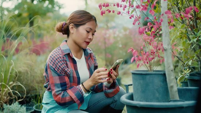 Young Woman Using Smart phone in Garden