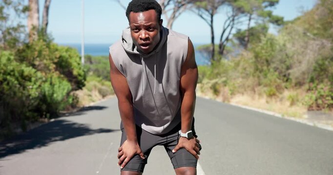 Running, tired and black man in city with time for exercise, tracking fitness and training outdoor. Sports, fatigue and person with wrist watch for workout performance, wellness and health on road