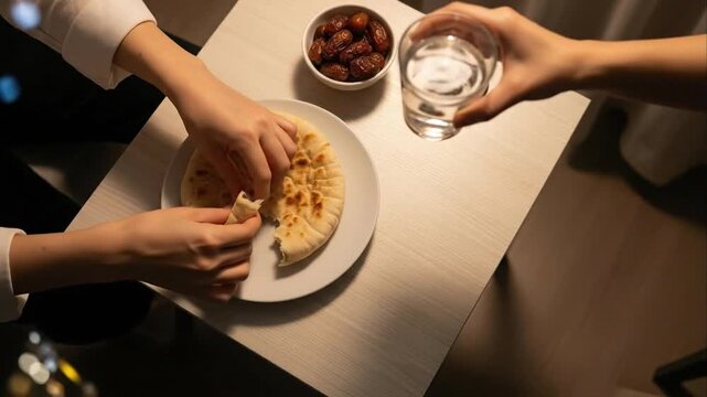 Hands reaching for food on a tabletop setting
