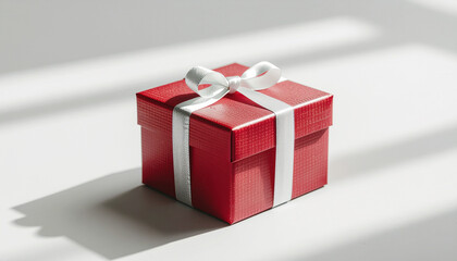 Obraz premium Minimalist Valentine gift concept, single red gift box with white ribbon on neutral