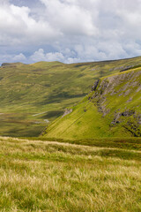 a wide panoramic view from the peak of a mountain over the Atlantic sea to the wild irish coast with a beautiful mountain range at sligo, ireland