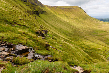 a small mountain waterfall at the mountain range next to the Ben Bulben in the area of gortnaleck sligo, ireland