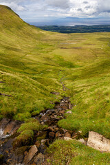 a small mountain waterfall at the mountain range next to the Ben Bulben in the area of gortnaleck sligo, ireland