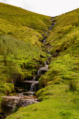 a small mountain waterfall at the mountain range next to the Ben Bulben in the area of gortnaleck sligo, ireland