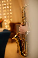 Medium closeup of unrecognizable Black jazz musician playing saxophone on stage in local bar