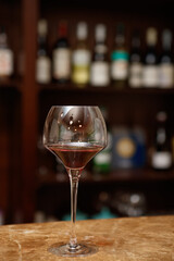 Honey white wine in glass. Pours wine from bottle into glass in restaurant. Wineglass. Evening aperitif. Alcohol beverage. Drink concept. Wine tasting. Candlelight dinner. Honey cider. Copy space.