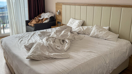 A sun-drenched room unveils a tangled bedspread, whispering tales of restless dreams, cozy cocooning, Hygge charm, and Sabbath serenity