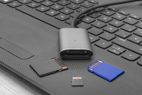 USB card reader with SD and MicroSD cards on keyboard.