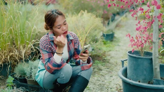 Young Woman Using Smart phone in Garden