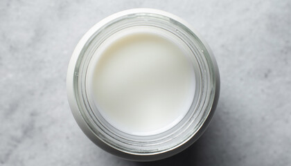 Close-up of luxurious cream in a glass jar on marble surface