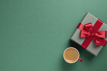 valentine's day theme background with a gift box and red ribbon bow on a green table